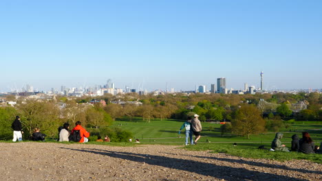 People-Sitting-And-Walking-At-Primrose-Hill-Park-In-London,-England