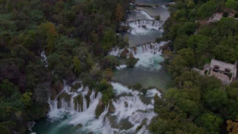Drone-shot-of-Waterfalls-At-Krka-National-Park-In-Croatia-during-sunrise,-aerial