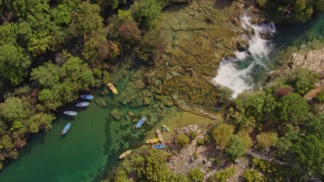Kayaking-in-crystal-clear-water-at-Zrmanja-river-Croatia-during-bright-sunny-day,-aerial