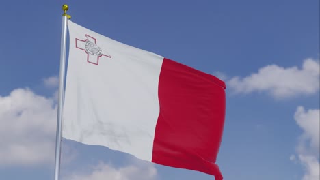 Flag-Of-Malta-Moving-In-The-Wind-With-A-Clear-Blue-Sky-In-The-Background,-Clouds-Slowly-Moving,-Flagpole,-Slow-Motion