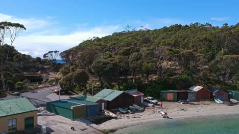 Pirates-Bay,-Tasmania,-Australia---12-March-2019:-Two-men-working-outside-the-boat-sheds-at-Pirates-Bay-in-Tasmania,-Australia