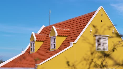 4k-24fps-slider-reveal-of-Caribbean-manor-AKA-landhuis-Wechi-in-Curacao,-classic-yellow-white-red-color-and-tiles