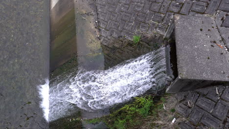 Waste-water-flows-out-from-the-sewer-pipe-into-the-river