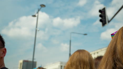 Close-up-shot-of-red-haired-woman-with-rainbow-ribbon-during-LGBT-community-pride-parade-in-Poland