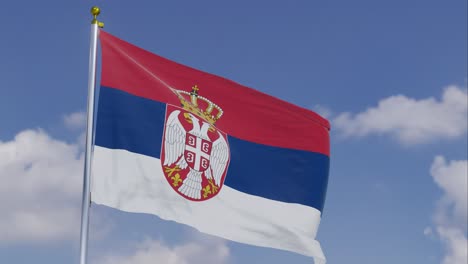 Flag-Of-Serbia-Moving-In-The-Wind-With-A-Clear-Blue-Sky-In-The-Background,-Clouds-Slowly-Moving,-Flagpole,-Slow-Motion
