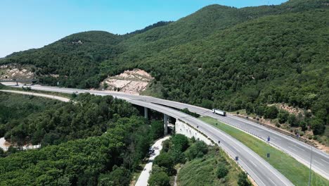 Different-vehicles-travelling-along-the-C-25-highway-Arbúcies,-Girona