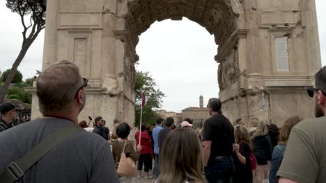 Gruppe-Von-Touristen-Mit-Reiseleiter,-Der-Die-Geschichte-Des-Titusbogens-Auf-Dem-Forum-Romanum-In-Rom-Erklärt