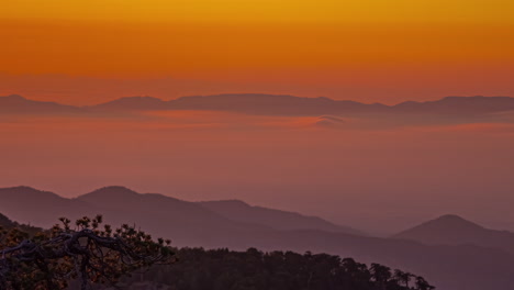 Sunset-timelapse-of-orange-yellow-mountains-and-low-clouds,-Cyprus