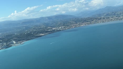 Panoramic-view-of-the-French-Riviera-from-an-airplane-cabin-in-a-right-turn-to-Nice-Airport