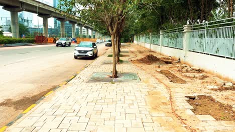 Brown-Dried-Dirt-on-the-Sidewalk-in-India-with-Flowing-Traffic