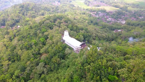 Fast-move-orbit-drone-shot-of-unique-chicken-shaped-church-in-the-middle-of-forest