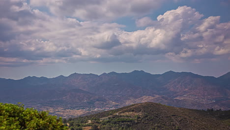 The-town-of-Limassol,-Cyprus-in-the-valley-below-the-mountains---cloudscape-time-lapse