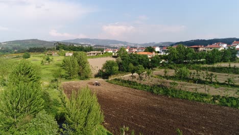 Agricultural-Field-and-Red-Tractor-Working-Aerial-View