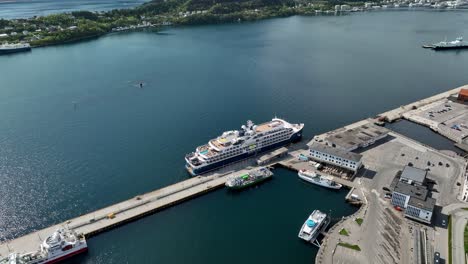 Luxury-Cruise-Ship-SH-Helena-alongisde-port-of-Aalesund-in-Norway-at-sunny-summer-day---Aerial