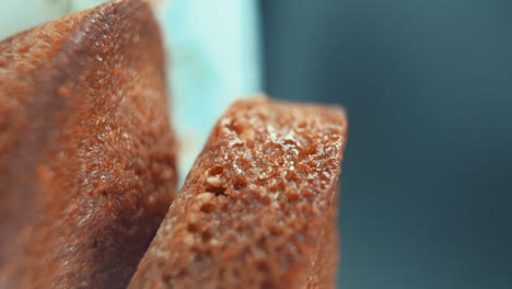 A-vertical-macro-close-up-crispy-shot-of-tasty-cupcakes,-on-a-360-rotating-stand,-studio-lighting,-super-slow-motion,-120-fps,-smooth-movement,-Full-HD-Video