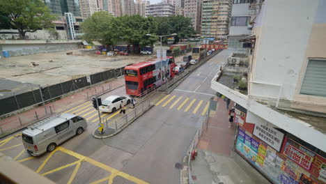 Aerial-top-down-shot-of-traffic-with-bus-and-cars-in-central-city-of-hong-kong-town---view-from-bridge