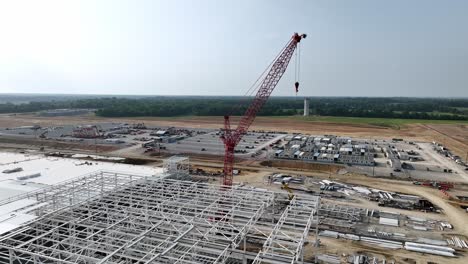 Aerial-approaching-BlueOval-City-crane-in-Stanton,-TN