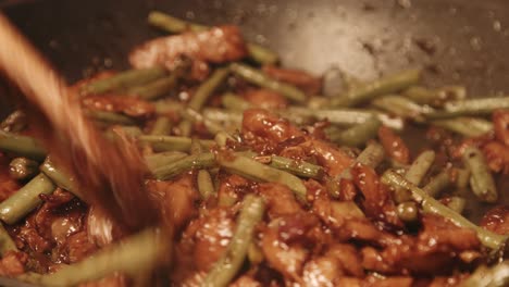 Wooden-Spoon-Stirring-Vegan-Pork-Teriyaki-Dish-with-Green-Beans-and-Red-Onions