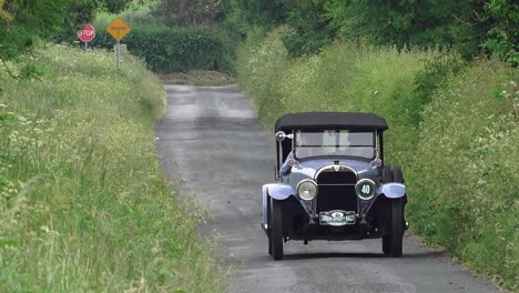 Vintage-car-driving-down-a-narrow-Irish-lane-in-summer-Irish-motoring-at-its-best