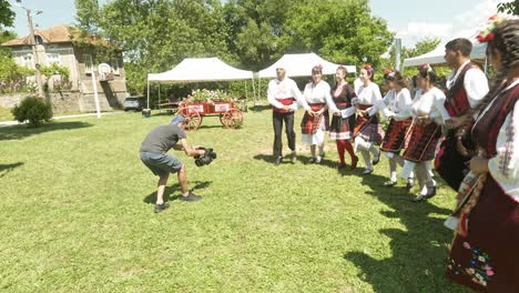 Local-news-films-people-in-traditional-dress-dancing-at-cultural-event