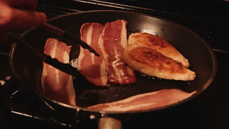Chef-Tongs-Turning-Over-Vegan-Bacon-in-Hot-Frying-Pan