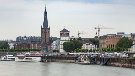 Dusseldorf-Old-town-and-Rhine-river-city-skyline-telephoto-timelapse,-overcast-weather