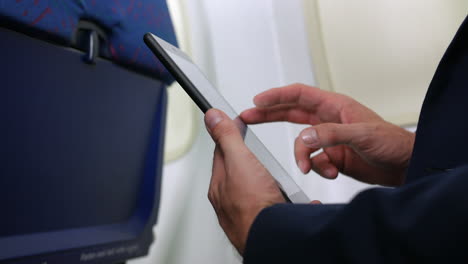 Nahaufnahme-Eines-Geschäftsmannes,-Der-Einen-Tablet-PC-In-Einem-Verkehrsflugzeug-Verwendet