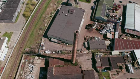 Flying-over-an-industrial-chimney,-tracking-drone-shot