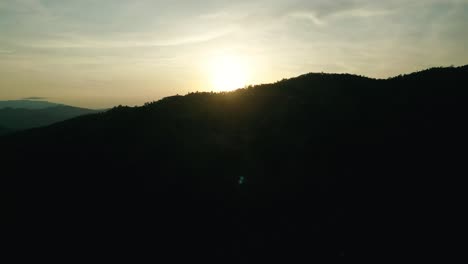 4K-Cinematic-nature-aerial-footage-of-a-drone-flying-over-the-beautiful-mountains-of-Chiang-Mai,-Thailand-during-sunset