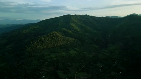 4K-Cinematic-nature-aerial-footage-of-a-drone-flying-over-the-beautiful-mountains-of-Chiang-Mai,-Thailand-during-sunset
