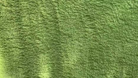 Green-colored-cloth-fluttering.-Background