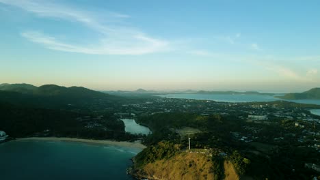 4K-Cinematic-nature-aerial-footage-of-a-drone-flying-over-the-beautiful-beaches-of-Promthep-Cape-in-Phuket,-Thailand-during-sunset