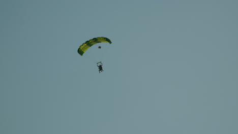 Tracking-shot-of-skydiver-flying-in-the-air-against-blue-sky-in-Poland---Wide-shot-bottom-up