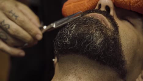 Portrait-Of-A-Man-Getting-Beard-Trimmed-At-A-Barber-Shop
