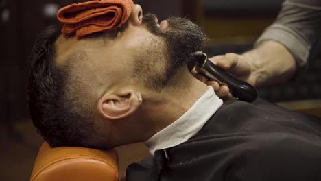 Friseur-Rasiert-Einen-Mann-Mit-Einem-Rasiermesser-Im-Friseurladen---Nahaufnahme