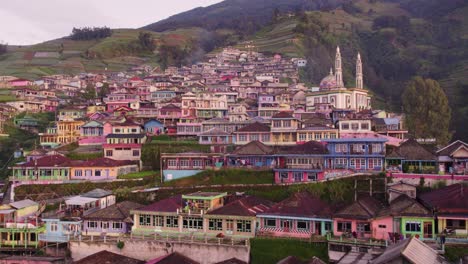 Reveal-shot-of-famous-Nepal-van-java-village-with-colourful-houses-during-sunrise,-aerial