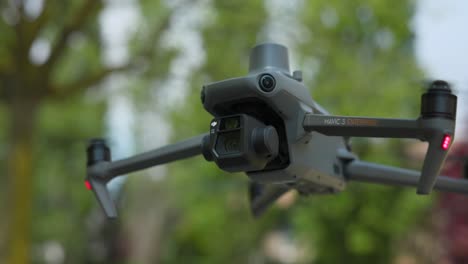 Close-Up-Shot-Of-DJI-Mavic-3E-Hovering-With-Bokeh-Background