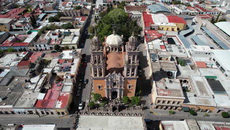 Aerial-drone-footage-moving-towards-the-Sanctuary-in-Jerez,-Zacatecas,-camera-tilts-down-to-a-cenital-view-as-it-approaches