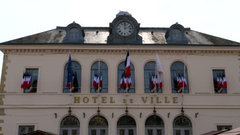 Panning-shot-of-luxury-french-hotel-de-ville-in-Honfleur-during-sunny-day---Panorama-view