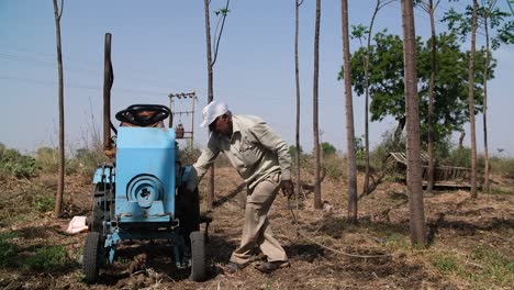 A-farmer-is-motoring-a-homemade-tractor-with-a-rope-that-will-be-used-in-his-farming-work