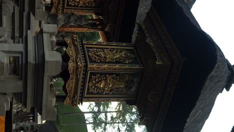 Vertical-slow-motion-establishment-shot-of-temple-building-at-pura-tirta-empul-water-temple-in-ubud-on-bali-indonesia