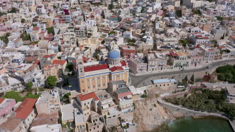 Aerial:-Slow-panning-drone-shot-of-Saint-Nicholas-church-in-Ermoupoli-of-Syros-island,-Greece-on-a-sunny-day