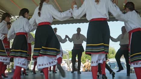 Dance-group-in-traditional-dress-dance-on-stage-at-cultural-event