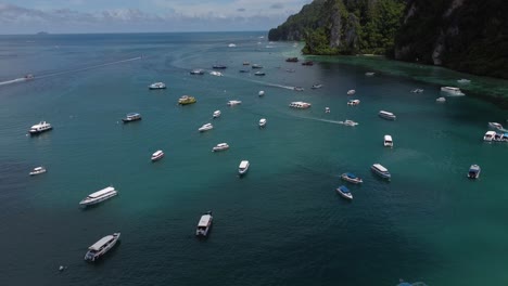Boats-near-phi-phi-island-coastline-carrying-tourists-and-passengers