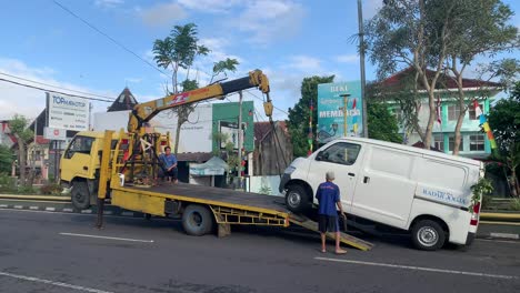 A-crashed-radar-jogja's-car-being-put-on-a-tow-truck-after-an-accident,-Indonesia---Jul-6,-2023