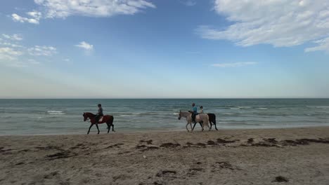 Equestrians-at-sunset-on-seashore