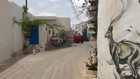 Walking-along-Djerbahood-colorful-alleys-of-open-air-street-art-of-Djerba-in-Tunisia