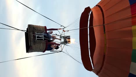 Vertikale-Zeitlupenaufnahme-Eines-Großen-Heißluftballons-Für-Eine-Ballonfahrt-Auf-Bali-In-Indonesien-Während-Einer-Abenteuerlichen-Reise-Durch-Die-Luft-Mit-Passagieren,-Die-Die-Aussicht-Genießen