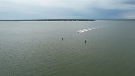 Drone-does-low-flyover-of-a-passenger-boat-heading-right-beneath-drone-on-overcast-morning-on-Hilton-Head-South-Carolina