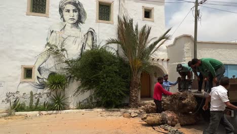 People-at-work-in-Djerbahood-painted-street-of-Djerba-in-Tunisia